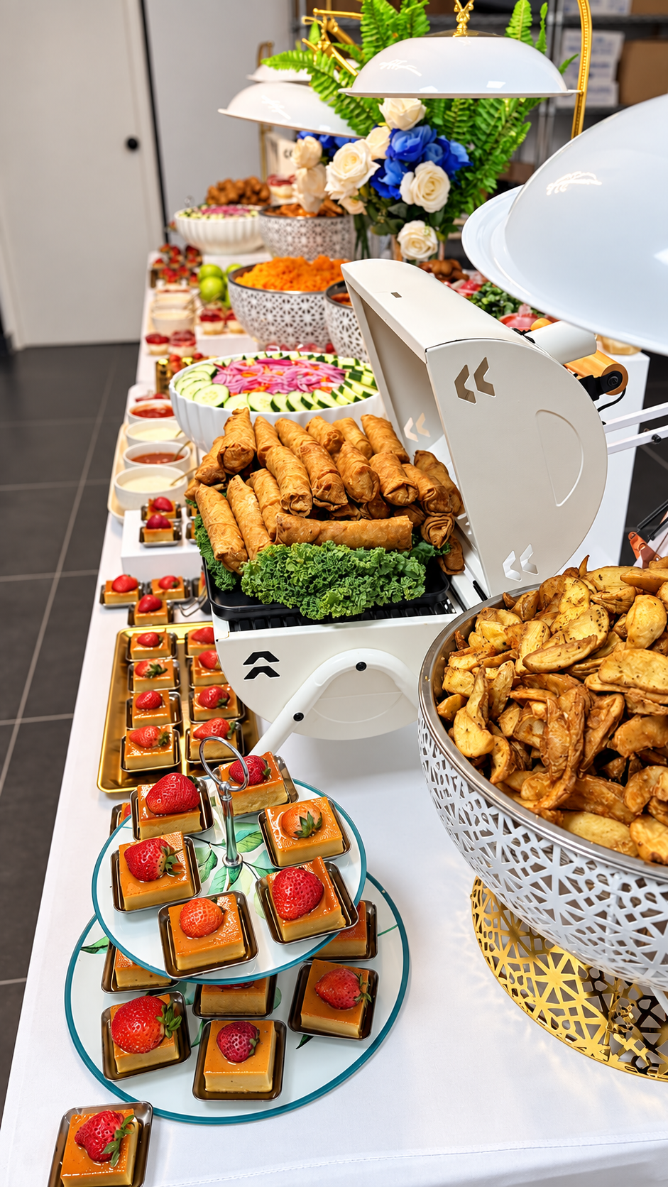 Buffet presentation featuring spring rolls, potato wedges and desserts